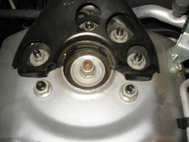 Unbolt and remove the shock tower brace