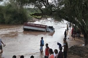 car tipping over in water, car in flood