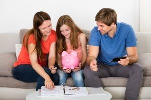 parents and daughter learn about finances