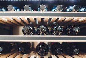 wine bottles in an upcycled refrigerator wine cellar