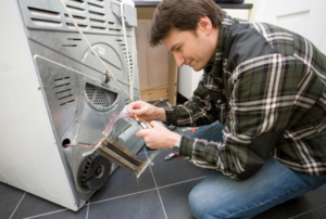 man repairing a dryer