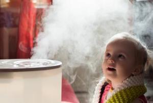 Young girl sitting in front of humidifier