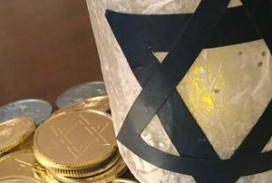 A Mason jar decorated with a Star of David surrounded by Hanukkah-themed candy.
