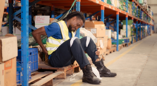 Warehouse worker with lower back pain.