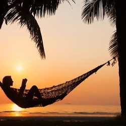 Woman in hammock at sunset