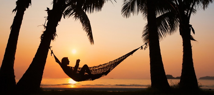Woman in hammock at sunset
