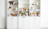 white shelving unit filled with kitchen essentials
