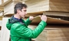 A man in a green jack choosing plywood.