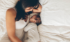 woman and baby laying in bed