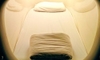 A sleeping pod with pillow and curved entrance