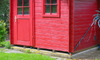 red shed with base on concrete