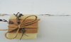 A piece of homemade organic goat milk soap tied with a piece of lavender and twine.