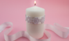 White candle with lace wrapped around it