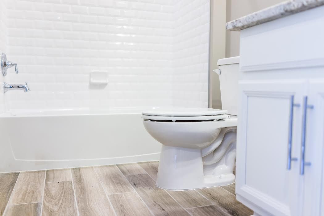 bathroom with white shower and cabinets