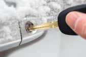 A key trying to ope a frozen car lock. 