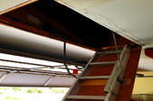 A ladder leading up to an above-garage attic.