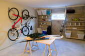 basement with bikes, skis, and a window