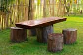 A picnic table and chairs made from logs.