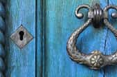 curved, metal, old fashioned doorknob on blue door