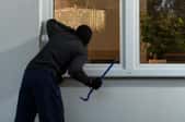 Burglar breaking into home window