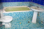 flooded bathroom with blue speckled tile