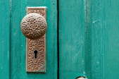 closeup of a teal door with doorknob