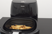 A Philips Airfryer with fries in the basket.