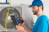 man evacuating air conditioning system with tools