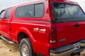 red pickup truck with camper shell