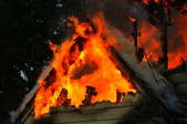 A house fire burning through an attic.