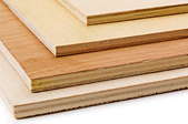 Several different types of plywood stacked on top of one another.