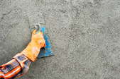 using a hand trowel on concrete