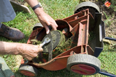 Cleaning the underside of a lawn mower