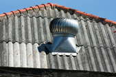 Galvanized roof with a fan and flashing.