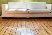 a reclaimed wood floor with a couch