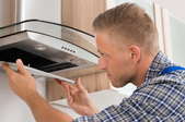 man fixing kitchen extractor fan
