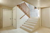 white concrete stairs descending into a lower room