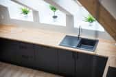 Black sink in long butcher block countertop