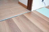 Wood floor meeting into tile floor in a doorway