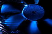 Extreme close-up of a spinning, blue fan.