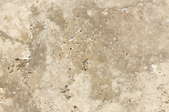 A close-up of the texture of travertine tile.
