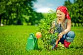 A little girl planting a tree on Earth Day.