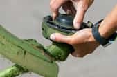 hand repairing lawn edge trimmer tool