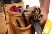 A close-up image of a leather belt with tools. 