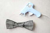 craft glue gun laying next to a bow tie