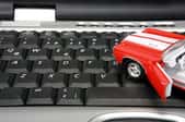 A toy car on a keyboard.
