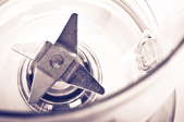 A close-up inside a blender pitcher, looking at the blades.