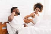 Couple with aches and pains in bed