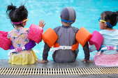 Three kids at a pool.