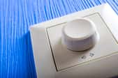 A white dimmer switch.